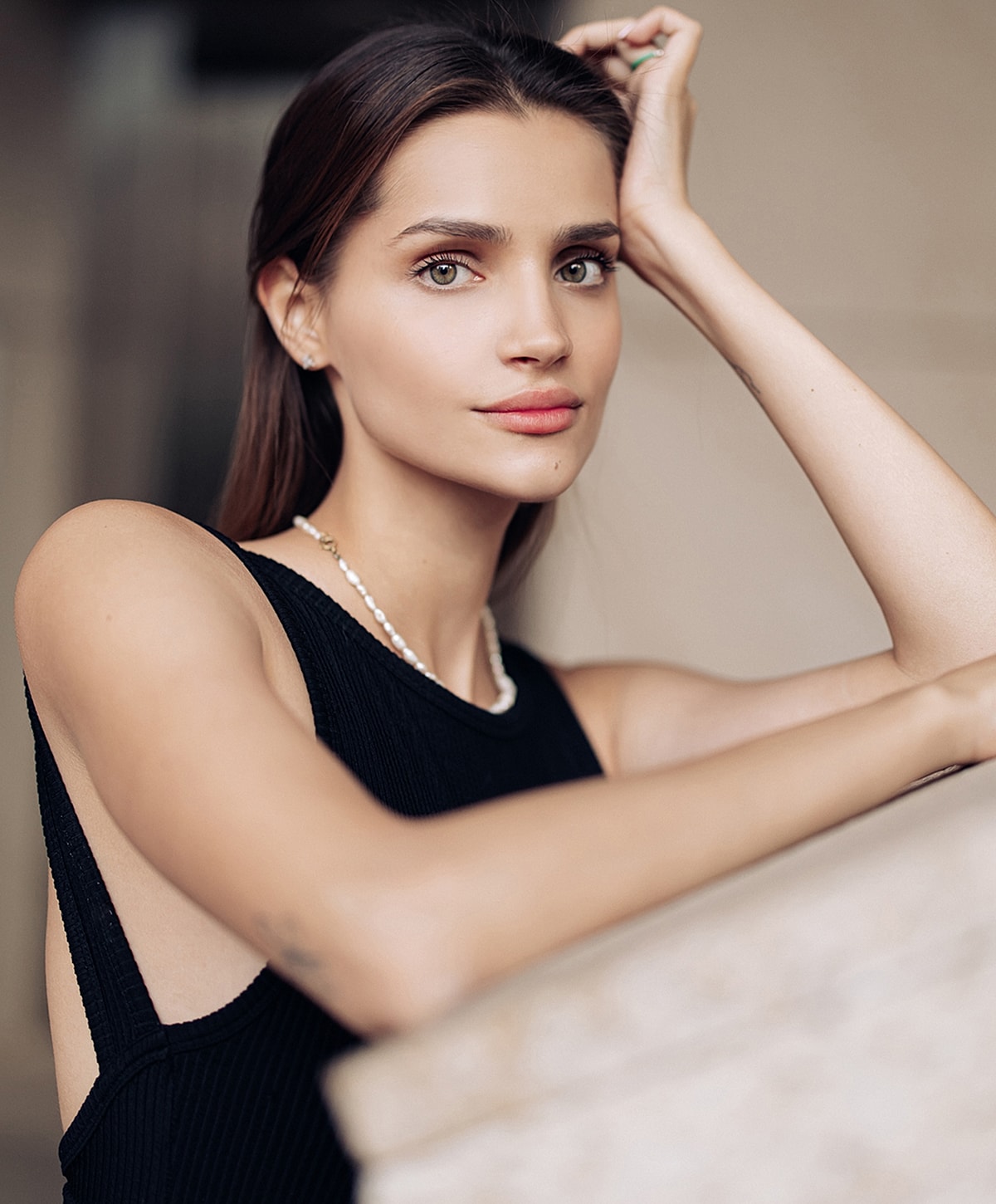 Woman in black dress with elegant pose.
