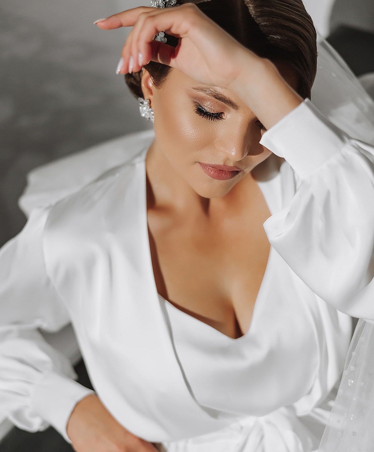 Bride with elegant makeup and stunning white gown.